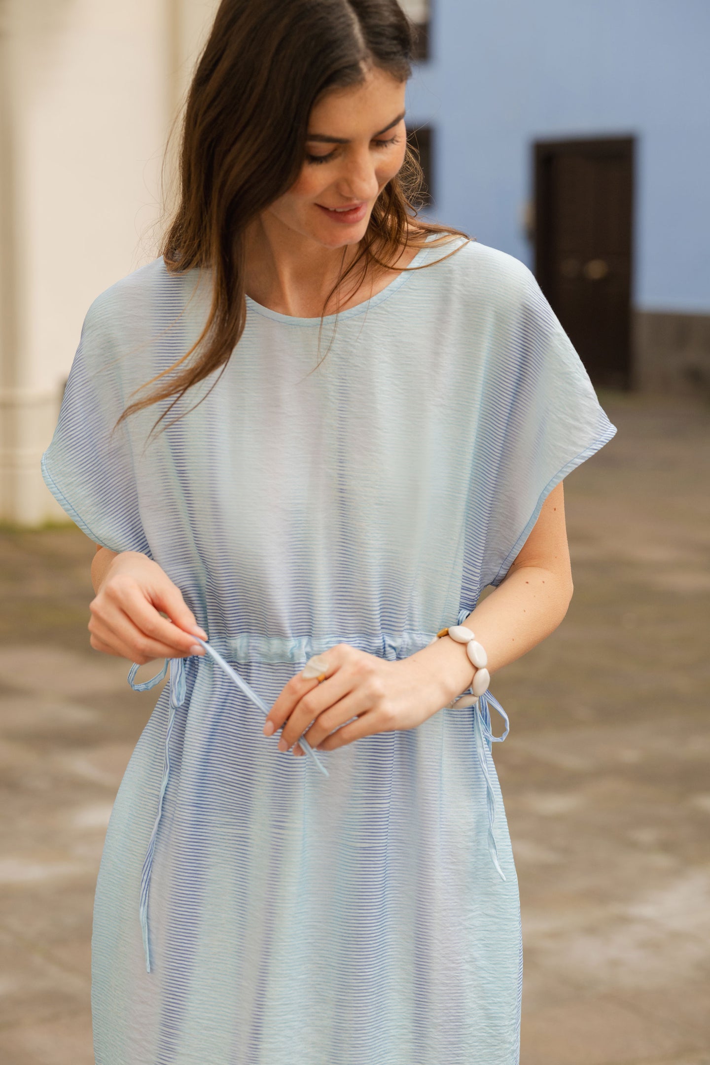 Woman wearing a light blue dress with a blurred background